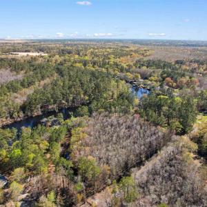 Birds eye view of property with a water view and a