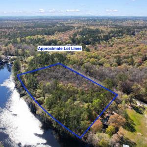 Birds eye view of property with a water view and a