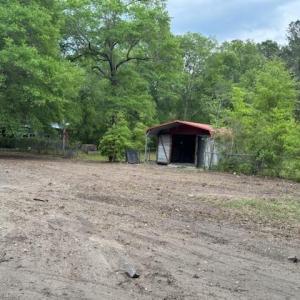 Exterior space featuring a detached carport and fe
