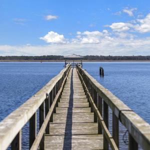 Dock area featuring a gazebo, a pier, and a water