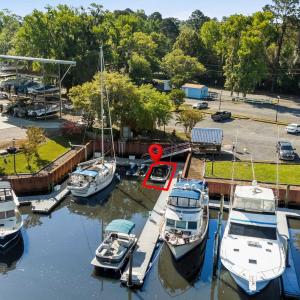 View of dock with a water view and a wooded view