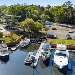 Dock area with a wooded view and a water view