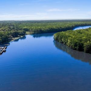 Bird's eye view featuring a forest view and a wate