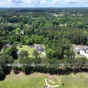 Birds eye view of property featuring a view of tre