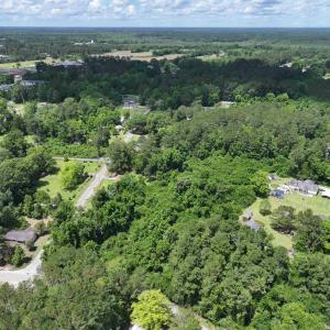 Birds eye view of property featuring a view of tre