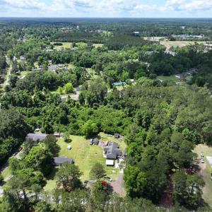 Aerial view featuring a wooded view
