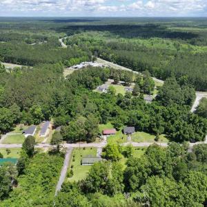 Birds eye view of property featuring a wooded view