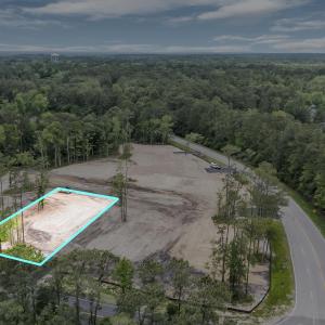 Birds eye view of property with a wooded view
