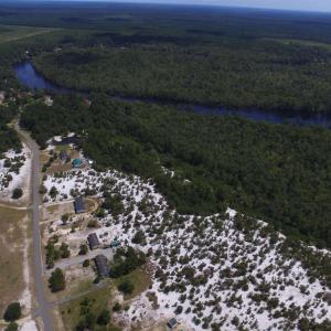 View of property location featuring a forest and a