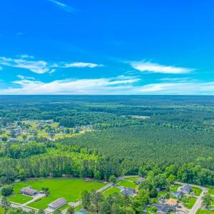 Aerial view of property and surrounding area with