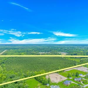 Aerial view of property and surrounding area with