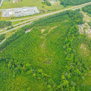 Aerial view of property's location with a forest