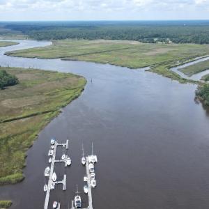 Aerial view of a nearby body of water and a heavil