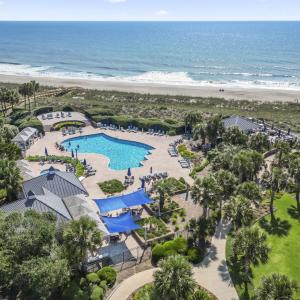 Aerial view of waterfront with a beach and a pool