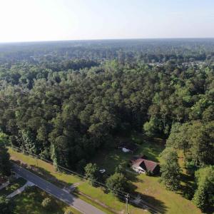 Aerial view of property's location with a forest