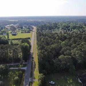 View of property location with a heavily wooded ar