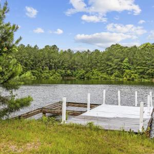 Dock featuring a water view and a view of trees