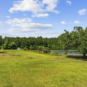 View of grassy yard featuring a water view, a view