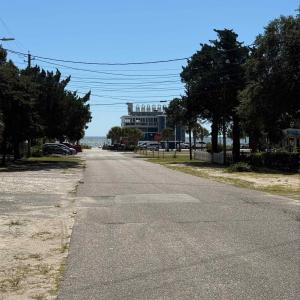 View of asphalt street featuring traffic signs