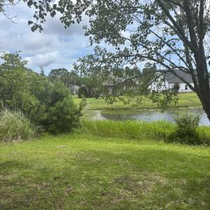 View of green lawn with a water view