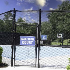 View of basketball court featuring a gate