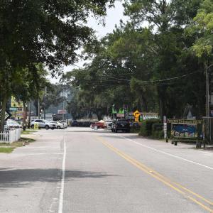 View of asphalt road featuring traffic signs