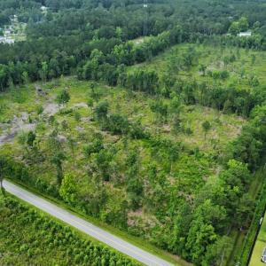 Aerial view of property's location with a forest