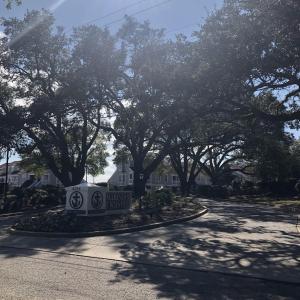 View of asphalt road with curbs and a residential