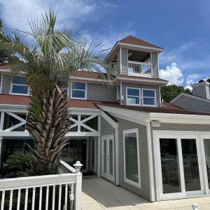Back of property featuring a balcony, french doors
