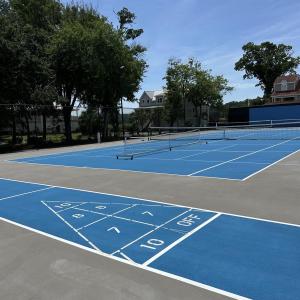 View of community with a tennis court
