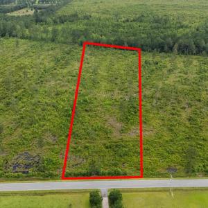 View of property location with a forest and proper