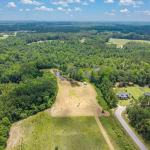 Aerial view of property and surrounding area with