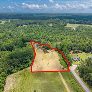 View of property location featuring a forest and p