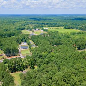 View of property location with a heavily wooded ar