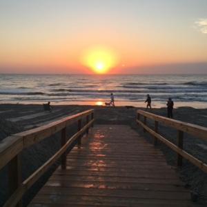 Dock area with view of water and beach
