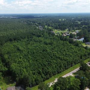 View of property location featuring a forest