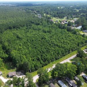 Aerial view of property's location with a forest
