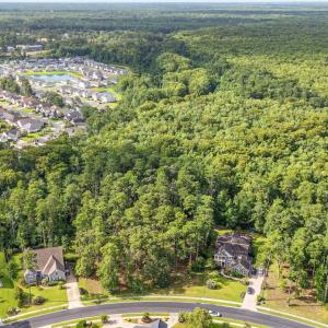 View of property location featuring a forest and n