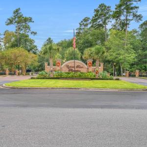 Community sign with view of wooded area