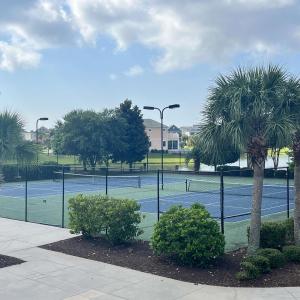 View of property's community with a tennis court,