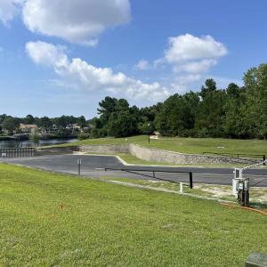 View of street featuring curbs, a water view, stre