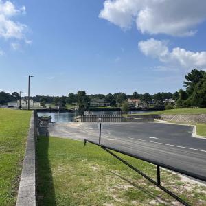 View of asphalt street with a water view, curbs, a