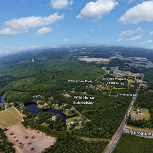 View of property location with a forest and proper