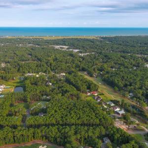 View of property location featuring a forest and a
