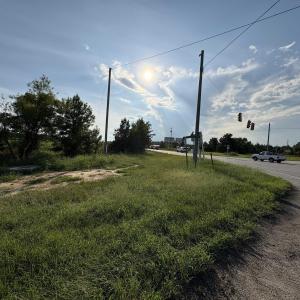 View of asphalt road featuring traffic lights