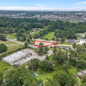 Aerial view of property's location featuring a tre