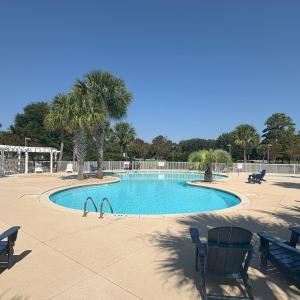 Community pool featuring a patio and a pergola
