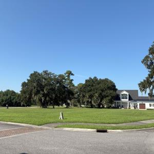 View of property's community with a yard