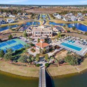 Aerial view of a nearby body of water and a pool a
