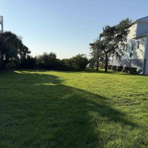 View of green lawn featuring a garage